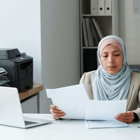 A certified translator formats an Arabic birth certificate for USCIS, using Arabic Translation Services in Houston.