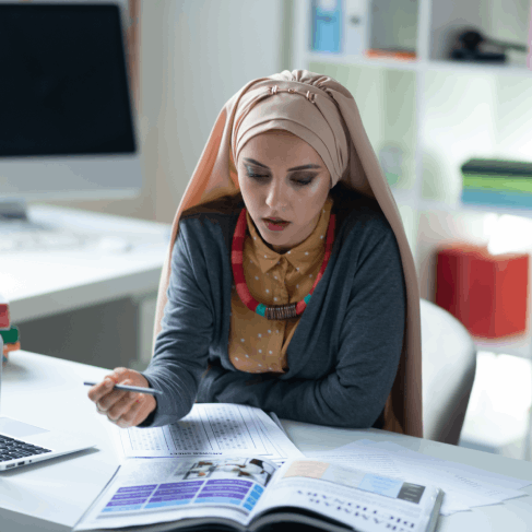 A translator edits an Arabic thesis on a laptop, providing Arabic Translation Services in Houston for academic documents.