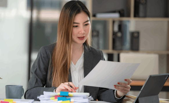 A certified translator reviews a contract for Vietnamese Translation Services in Houston, ensuring the legal wording matches.