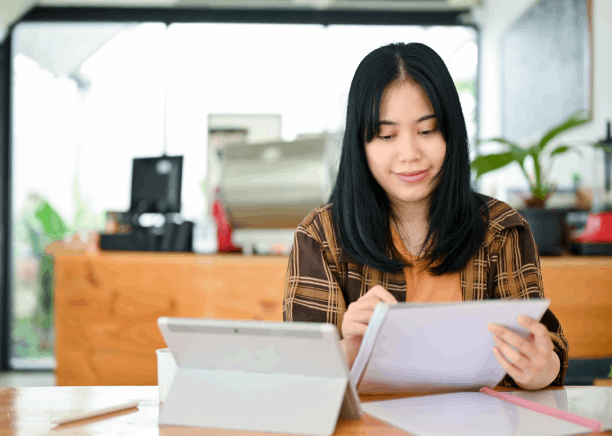 An English translator reviews a Vietnamese document at a Houston desk, providing Vietnamese Translation Services in Houston.