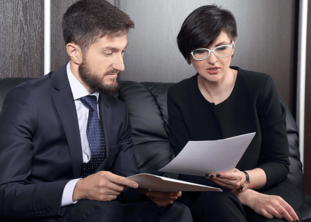 Translators review an English contract with a Vietnamese speaker in Houston, providing Vietnamese Translation Services.